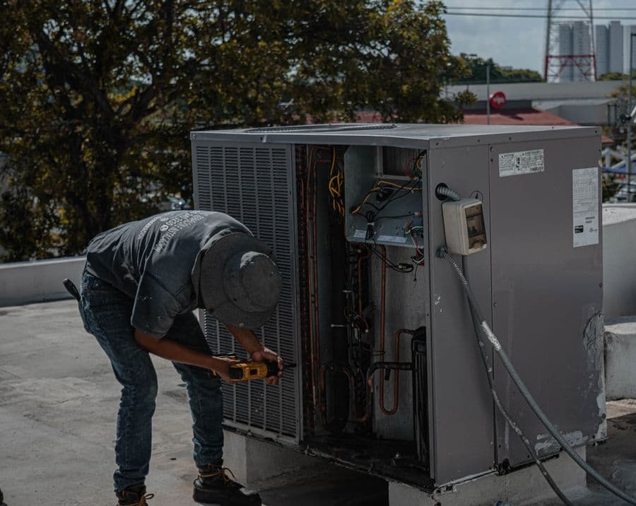 Technician installing a new AC unit